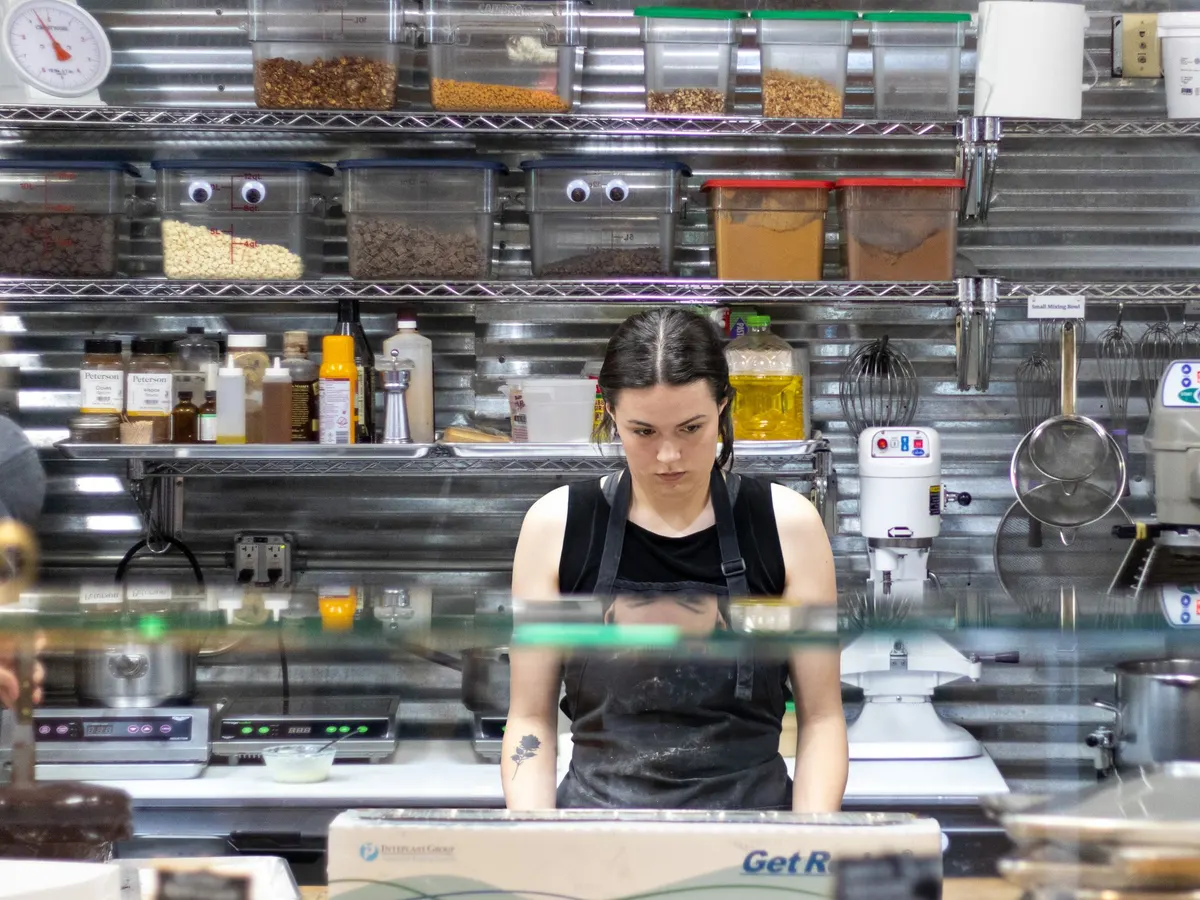 Cook working in a stainless steel industrial kitchen